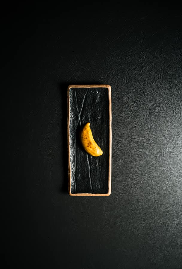 A single bite served on black slate