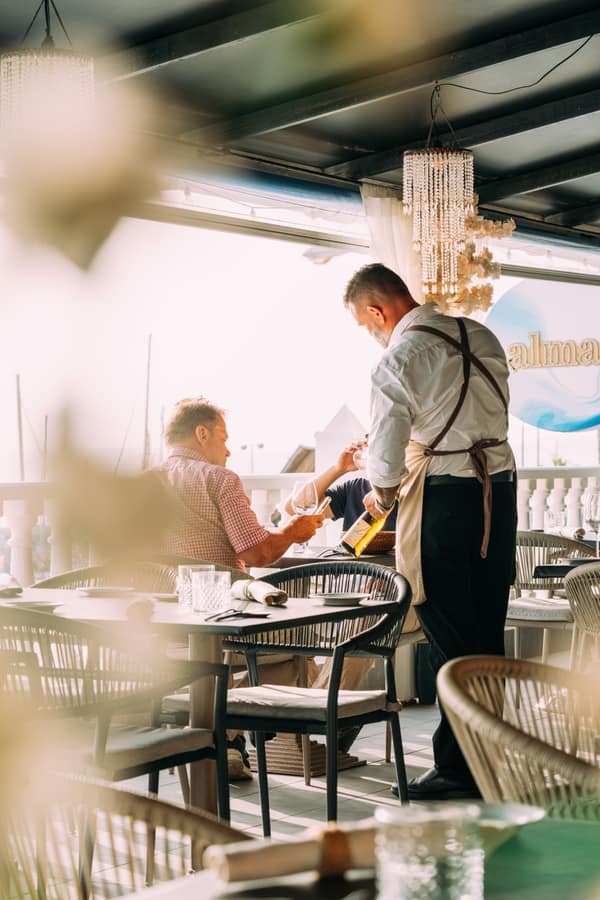 Wine being served at a table by the balustrade