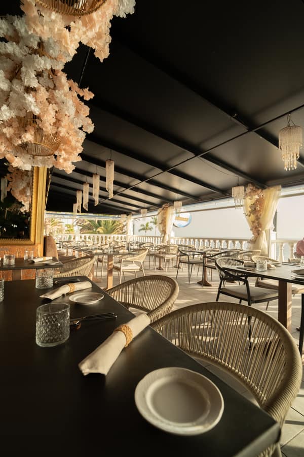 Terrace tables beneath the floral ceiling installation